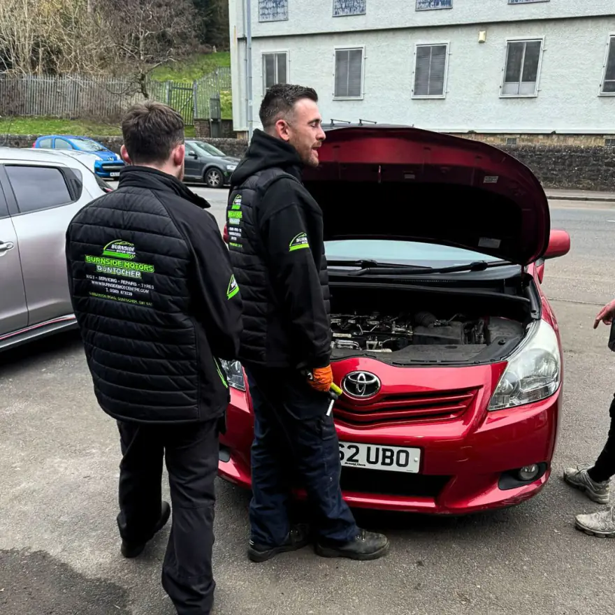 Two Burnside Motors technicians checking over an engine bay in Clydebank