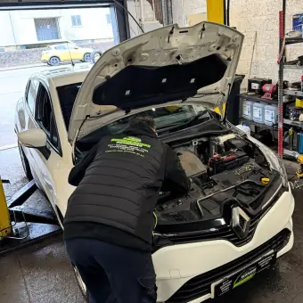 Car servicing and engine bay work at Burnside Motors, Duntocher