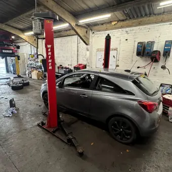 MOT test in progress on a car lift at Burnside Motors, Clydebank